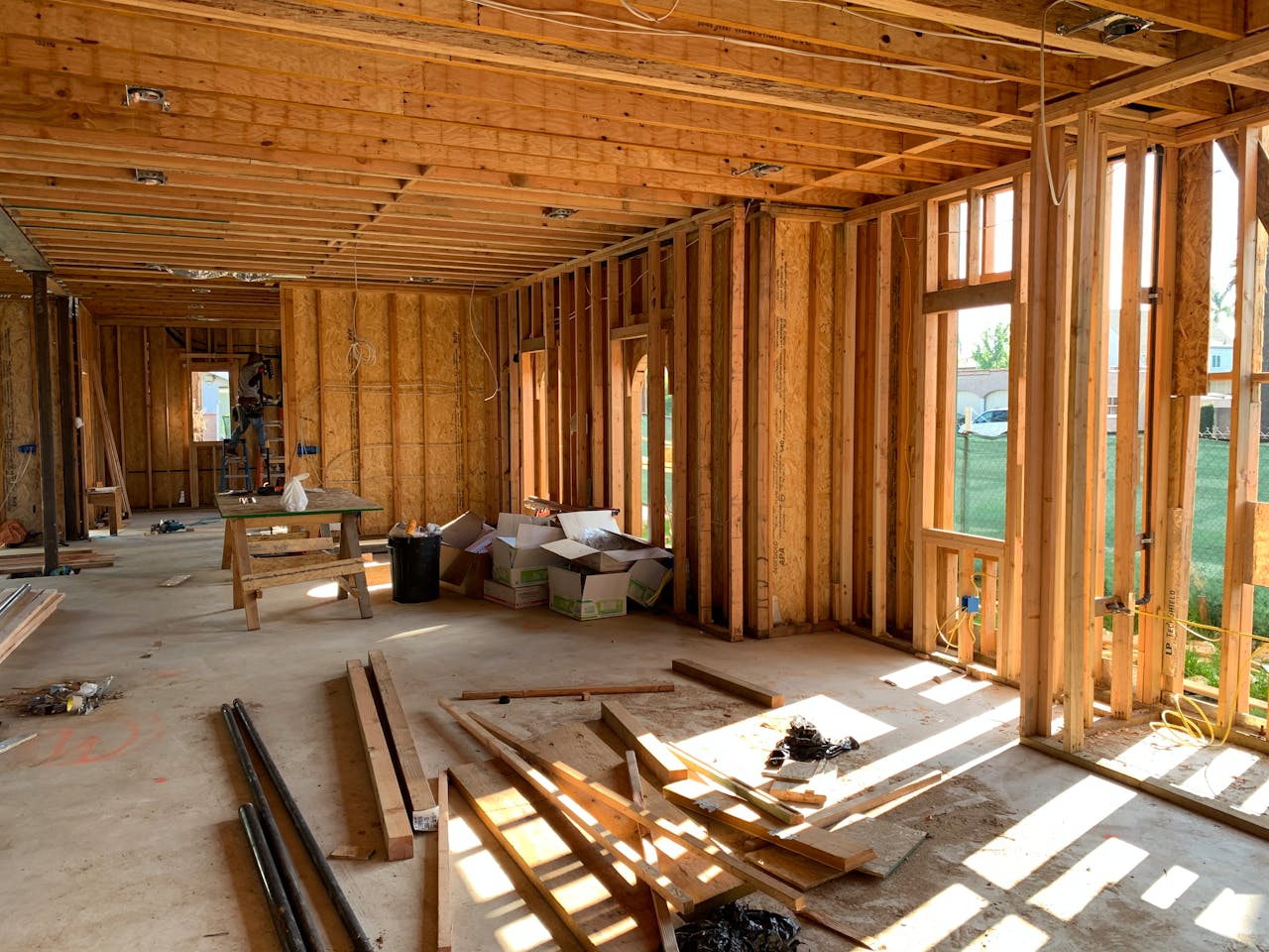 Crafting Captivating Headlines: Your awesome post title goes here Sunlit interior with wood framing, showcasing home construction progress.